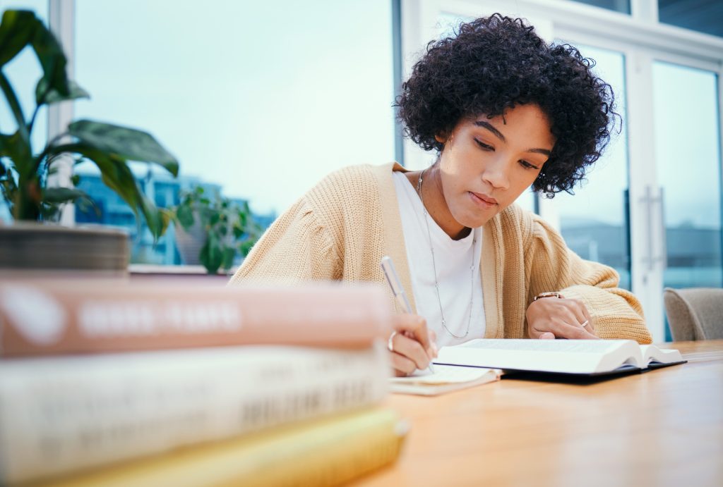Bible, religion and woman with study of theology in home, Christian faith and knowledge of God for